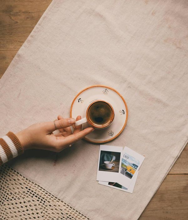 A minimalist interior with a yoga mat on a wooden floor, bathed in soft morning light.