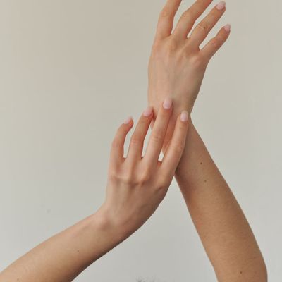 Close-up of hands in a graceful position during a stretch.